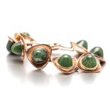 A JADE-LIKE STONE BRACELET composed of eight textured triangles, centred with a round cabochon