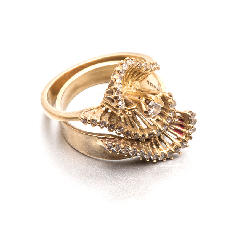 A DIAMOND RING of abstract design, claw-set with round brilliant-cut diamonds weighing approximately