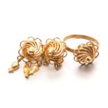 A GOLD RING centred with an openwork domed swirl, impressed 22k, acid tested as 18ct gold, size N;