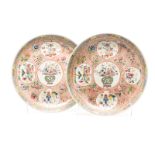 A PAIR OF CHINESE FAMILLE ROSE CHARGERS each with the central rondel depicting a jardinière filled