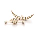 AN OPAL AND DEMANTOID GARNET BROOCH of crescent form, set with oval opals of graduating sizes,