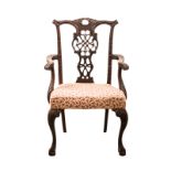 A GEORGE III MAHOGANY ARMCHAIR the shaped, pierced and carved top rail above a pierced and carved