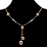 AN 18CT GOLD NECKLACE composed of rolo-link chain, set to the centre with hollow spheres and