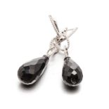 A PAIR OF ONYX AND DIAMOND PENDANT EARRINGS each surmount designed as a line embellished with
