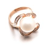 A PEARL AND DIAMOND RING in the form of a stylised flower, centred with a pearl, diameter