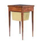 A MAHOGANY AND INLAID WRITING TABLE the hinged crossbanded top enclosing a gilt-tooled leather-