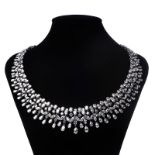 AN 18K WHITE GOLD AND DIAMOND COLLAR NECKPIECE with a row of alternating pear and round brilliant-