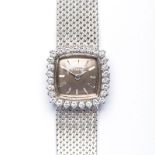 A LADIES 18K WHITE GOLD WRISTWATCH, ETERNA automatic, the square gold dial applied with baton hour