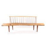 A KIAAT AND YELLOWWOOD SPINDLEBACK BENCH, 21ST CENTURY the curved top rail above an organic-shaped