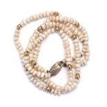 A DOUBLE STRAND PEARL NECKLACE irregular half pearls with circular bead spacers the shortest