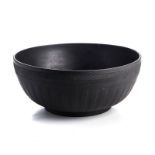 A WEDGEWOOD BLACK BASALT BOWL, 20TH CENTURY the exterior with incised chevron design and ribbed