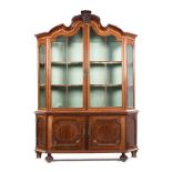 A DUTCH MAHOGANY DISPLAY CABINET, 19TH CENTURY in two parts, the gabled top centred by a key block
