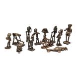 A GROUP OF ELEVEN ASHANTI GOLD WEIGHTS, GHANA comprising: a fish and 10 figures at various pursuits;