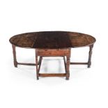 A CAPE TEAK PEG-TOP GATE-LEG TABLE, LATE 18TH/EARLY 19TH CENTURY the hinged oval top, above a
