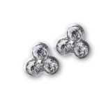 A PAIR OF WHITE GOLD AND DIAMOND EARSTUDS each with three tube-set diamonds approximately 0.15ct