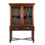 A CAPE STINKWOOD CABINET-ON-STAND, LATE 18TH/EARLY 19TH CENTURY in two parts, the outswept moulded