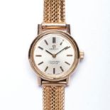 A LADIES 22K YELLOW GOLD VINTAGE OMEGA SEAMASTER DE VILLE the circular gold dial with hour markers