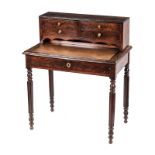 A FLAME MAHOGANY WRITING TABLE the moulded rectangular top with a gilt-tooled leather-inset