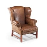 A CLOSENAILED OSTRICH LEATHER AND OAK WINGBACK ARMCHAIR the padded back and sides above a loose seat