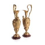 A PAIR OF LOUIS XVI ORMOLU EWERS each spout with moulded griffins, the slender shaped handle adorned