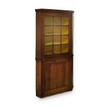 A MAHOGANY CORNER CUPBOARD, 19TH CENTURY in two parts, the outswept cornice with canted corners