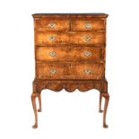 A WALNUT CHEST-ON-STAND, 18TH CENTURY in two parts, the crossbanded rectangular top above an