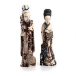 A PAIR OF CHINESE CARVED AND PAINTED IVORY FIGURES OF AN OFFICIAL AND A MAIDEN NOT SUITABLE FOR