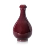 A CHINESE SANG-DE-BOUEF GARLIC-NECK BOTTLE VASE, 18TH CENTURY glazed overall with a deep red