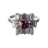 AN ART DECO STYLE RUBY AND DIAMOND RING centred with a claw-set oval mixed-cut ruby weighing