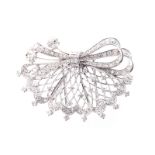 A DIAMOND BROOCH designed as an openwork fan with ribbon detail, set throughout with round