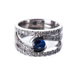 A SAPPHIRE AND DIAMOND RING the trifurcate band highlighted with round brilliant0cut diamonds,