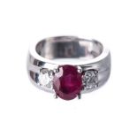 A RUBY AND DIAMOND RING Centred with an oval mixed-cut ruby weighing approximately 1.50cts,