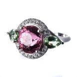 A DIAMOND, PINK AND GREEN TOURMALINE RING centred with an oval mixed-cut pink tourmaline weighing