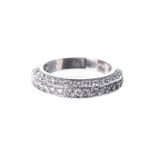 A DIAMOND RING pave-set to the centre and either side with round brilliant-cut diamonds weighing