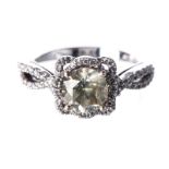 A DIAMOND RING centred with a bezel-set round brilliant-cut diamond, within a square-shaped surround