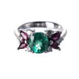 AN EMERALD, RUBY AND DIAMOND RING centred with an oval modified brilliant-cut emerald weighing 1.