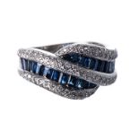 A SAPPHIRE AND DIAMOND RING of stylised design, centred with channel-set baguette-cut sapphires,