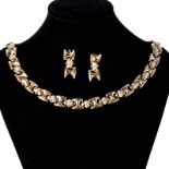 AN 18CT GOLD AND DIAMOND NECKLACE composed of stylised H-shaped links alternating with a stylised