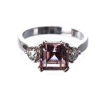 A TOURMALINE AND DIAMOND RING centred with a peach pink princess-cut tourmaline weighing