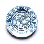 A CHINESE BLUE AND WHITE ‘KRAAK’ DISH the central rondel depicting a figure amongst rockwork and