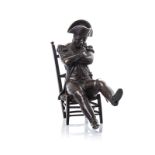 A PATINATED BRONZE FIGURAL SCULPTURE OF NAPOLEON BONAPARTE seated with arms crossed, probably part