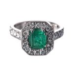 AN EMERALD AND DIAMOND RING centred with an emerald-cut emerald weighing approximately 1.10cts,