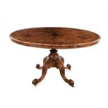A LATE VICTORIAN WALNUT LOO TABLE the oval quarter-veneered top above a plain frieze, on a carved