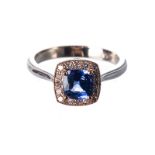 A TANZANITE AND DIAMOND RING centred with a cushion-cut tanzanite weighing approximately 1.08cts.