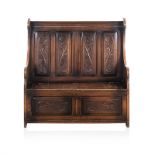A FRUITWOOD MONKS BENCH, 19TH CENTURY the reeded top rail above four foliate carved panels between