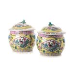 A PAIR OF CHINESE YELLOW GROUND URNS WITH COVERS each globular body painted with scalloped panels