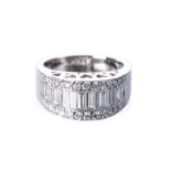 A DIAMOND RING the broad raised band channel-set to the centre with baguette-cut diamonds flanked