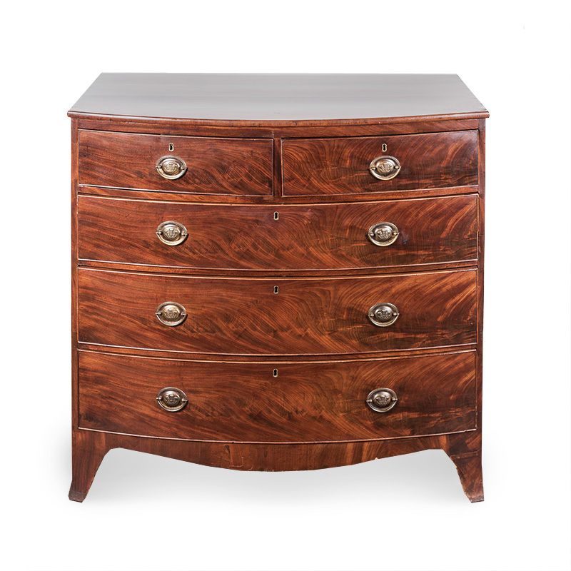A VICTORIAN MAHOGANY CHEST OF DRAWERS the outswept top above six ogee drawers, on four turned bun