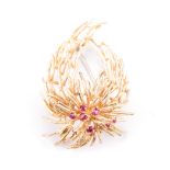 A YELLOW GOLD AND RUBY BROOCH