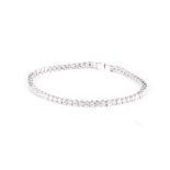 AN 18K WHITE GOLD TENNIS BRACELET